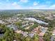 Community aerial view featuring lush landscaping, a serene lake, and well-maintained residential properties at 203 W Tarrington Dr, Deland, FL 32724