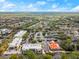 An aerial view showcasing the community's commercial center with multiple shops, restaurants, and ample parking at 203 W Tarrington Dr, Deland, FL 32724