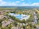 An aerial view of the neighborhood lake, surrounded by lush landscaping and residential homes at 203 W Tarrington Dr, Deland, FL 32724