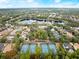 Community aerial view featuring tennis courts, a pool, a lake, and residential properties at 203 W Tarrington Dr, Deland, FL 32724