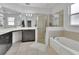 Bathroom with soaking tub, tiled shower, and vanity at 203 W Tarrington Dr, Deland, FL 32724