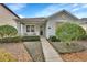 Charming one-story home featuring a covered porch and lush landscaping in a well-maintained front yard at 203 W Tarrington Dr, Deland, FL 32724