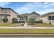 Charming one-story home featuring manicured landscaping and a well-maintained front yard at 203 W Tarrington Dr, Deland, FL 32724