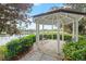 Charming gazebo with seating overlooking the tranquil community lake, surrounded by manicured hedges at 203 W Tarrington Dr, Deland, FL 32724