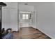 Hallway with hardwood floors, access to other rooms, and natural light at 203 W Tarrington Dr, Deland, FL 32724