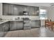 Modern kitchen with granite countertops, stainless steel appliances, and sleek dark cabinetry at 203 W Tarrington Dr, Deland, FL 32724