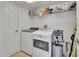 Laundry room with washer, dryer, shelving, and tiled floors at 203 W Tarrington Dr, Deland, FL 32724
