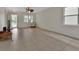 Spacious living room featuring tile flooring, ceiling fan, and bright natural light at 203 W Tarrington Dr, Deland, FL 32724