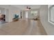 Bright living room with tile flooring, ceiling fan, and natural light at 203 W Tarrington Dr, Deland, FL 32724