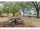 Close up view of the park benches under mature trees, with lake access via a paved walking path in the background at 203 W Tarrington Dr, Deland, FL 32724