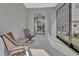 Screened patio with chairs, and view of home's interior through sliding door at 203 W Tarrington Dr, Deland, FL 32724