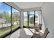 Screened patio with outdoor chairs and view of backyard at 203 W Tarrington Dr, Deland, FL 32724