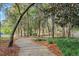 Scenic winding walking path through mature trees with Spanish moss, offering a peaceful community retreat at 203 W Tarrington Dr, Deland, FL 32724