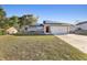 Single-story home with a large front yard and solar panels, providing energy efficiency at 2129 E Gloria Dr, Deltona, FL 32725