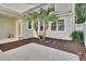 Charming backyard featuring decorative palm trees, mulch beds, and a serene outdoor space at 214 Woodhouse Ln, Deland, FL 32724