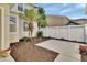 Well-maintained backyard featuring a white fence, lush mulch beds, and decorative palm trees at 214 Woodhouse Ln, Deland, FL 32724