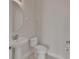 A half bathroom with a pedestal sink, commode, and neutral tile flooring at 214 Woodhouse Ln, Deland, FL 32724