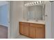 Double vanity bathroom with dual sinks, large mirror, ample lighting and tile floors at 214 Woodhouse Ln, Deland, FL 32724