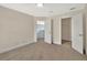 This is a spacious bedroom with neutral walls, carpet, and access to a closet at 214 Woodhouse Ln, Deland, FL 32724