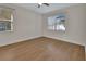 Bedroom with hardwood flooring, ceiling fan and natural lighting from multiple windows at 214 Woodhouse Ln, Deland, FL 32724