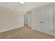 Bedroom with carpeted flooring, ceiling light and large closet with double doors at 214 Woodhouse Ln, Deland, FL 32724