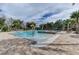 Community pool area featuring palm tree water features, lounge chairs, and a inviting space for relaxation and recreation at 214 Woodhouse Ln, Deland, FL 32724