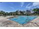 Community pool area featuring lounge chairs, manicured palm trees and a clean, inviting space for recreation at 214 Woodhouse Ln, Deland, FL 32724