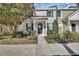 Charming two-story townhome with landscaped yard and inviting entryway at 214 Woodhouse Ln, Deland, FL 32724