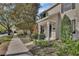 Elegant two-story home featuring a covered porch, lush landscaping, and a neatly maintained lawn at 214 Woodhouse Ln, Deland, FL 32724