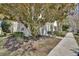 Charming home with a well-manicured garden, mature trees, and a welcoming entrance at 214 Woodhouse Ln, Deland, FL 32724