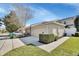 Beige garage and driveway showcasing an attached unit with manicured landscaping and ample parking at 214 Woodhouse Ln, Deland, FL 32724