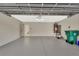 Spacious garage with white cinderblock walls and painted concrete flooring, providing a clean and functional space at 214 Woodhouse Ln, Deland, FL 32724