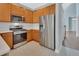 Modern kitchen featuring stainless steel appliances and ample cabinet space at 214 Woodhouse Ln, Deland, FL 32724