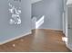 Spacious living room with hardwood floors, tall ceilings, and a modern, minimalist design at 214 Woodhouse Ln, Deland, FL 32724