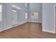 Open-concept living room with hardwood floors, tall ceilings, and an inviting entryway at 214 Woodhouse Ln, Deland, FL 32724