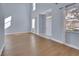 Bright living room featuring hardwood floors, tall ceilings, and an inviting entryway at 214 Woodhouse Ln, Deland, FL 32724