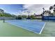Well-maintained tennis courts for active community lifestyle with lush surrounding greenery and lighting for evening play at 214 Woodhouse Ln, Deland, FL 32724