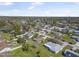 Aerial view of a peaceful residential neighborhood with tree-lined streets and well-maintained homes at 2216 Umbrella Tree Dr, Edgewater, FL 32141