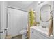 Bright bathroom featuring a toilet, a vanity with sink, a mirror and a shower at 2216 Umbrella Tree Dr, Edgewater, FL 32141