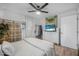 Bedroom features a ceiling fan, wood floors, and natural light from the window at 2216 Umbrella Tree Dr, Edgewater, FL 32141