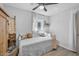 Neutral bedroom featuring a ceiling fan, wood floors, and natural light from the window at 2216 Umbrella Tree Dr, Edgewater, FL 32141