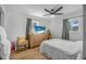This bedroom has a ceiling fan, hardwood floors, and a mounted tv at 2216 Umbrella Tree Dr, Edgewater, FL 32141