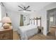 Bedroom features a ceiling fan, wood floors, and natural light from the window at 2216 Umbrella Tree Dr, Edgewater, FL 32141