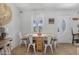 Bright dining area with light wood floors, a window and seating for four at 2216 Umbrella Tree Dr, Edgewater, FL 32141