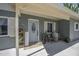 Charming front entrance featuring a stylish door, seating area, and well-maintained landscaping at 2216 Umbrella Tree Dr, Edgewater, FL 32141