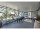 Bright enclosed patio with dining area and comfortable seating, perfect for relaxation and entertaining at 2216 Umbrella Tree Dr, Edgewater, FL 32141