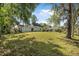 Large backyard featuring grass and trees at 2249 Swoope Dr, New Smyrna Beach, FL 32168