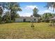 Wide backyard with plenty of green space and trees at 2249 Swoope Dr, New Smyrna Beach, FL 32168