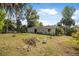 Expansive backyard with lush lawn and mature trees offers a private outdoor living space at 2249 Swoope Dr, New Smyrna Beach, FL 32168
