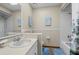 Cozy bathroom featuring blue rug, vanity with mirror and shower with tub at 2249 Swoope Dr, New Smyrna Beach, FL 32168